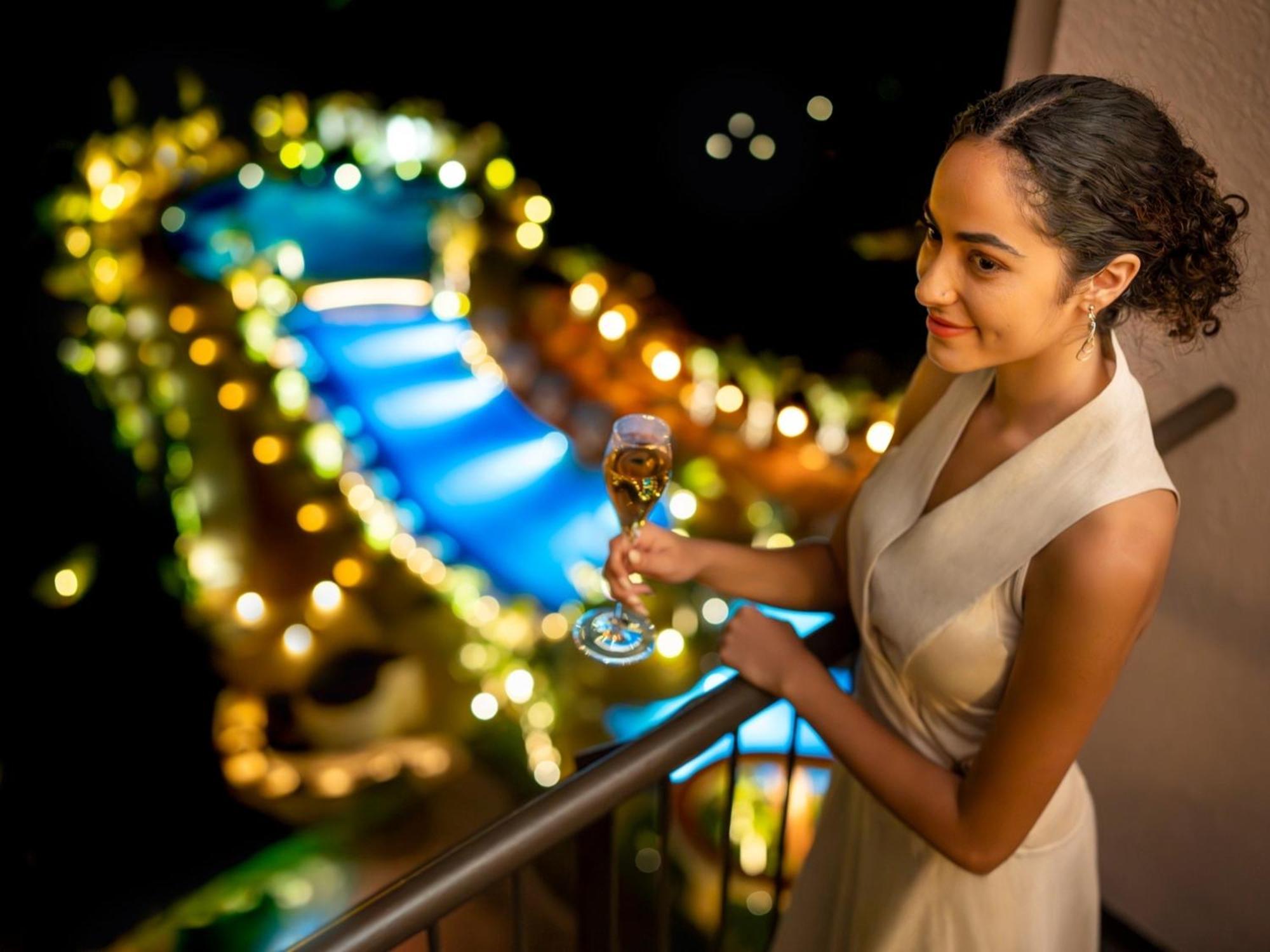 Oriental Hotel Okinawa Resort & Spa Nago Eksteriør billede A woman holding a glass of champagne